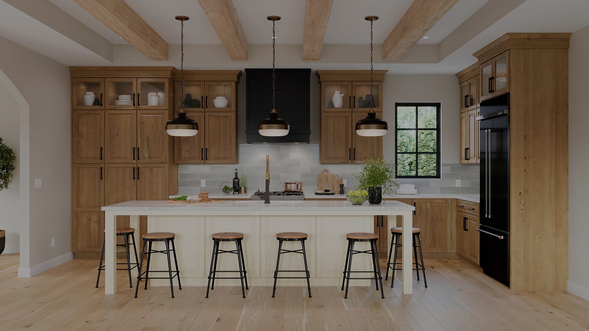 Two women look at their computer and phone in a beautiful Sage Green kitchen.